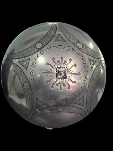 The Buga Sphere — a metallic spherical object with engraved symbols, photographed against a black background