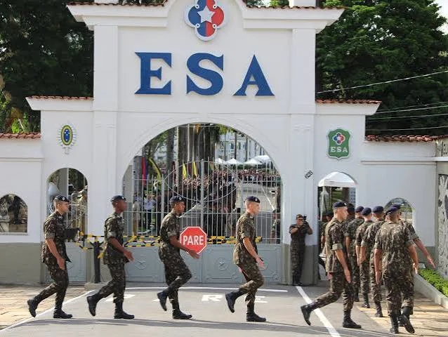 Soldiers marching past the entrance gate of the Escola de Sargentos das Armas (ESA) at Três Corações, Brazil